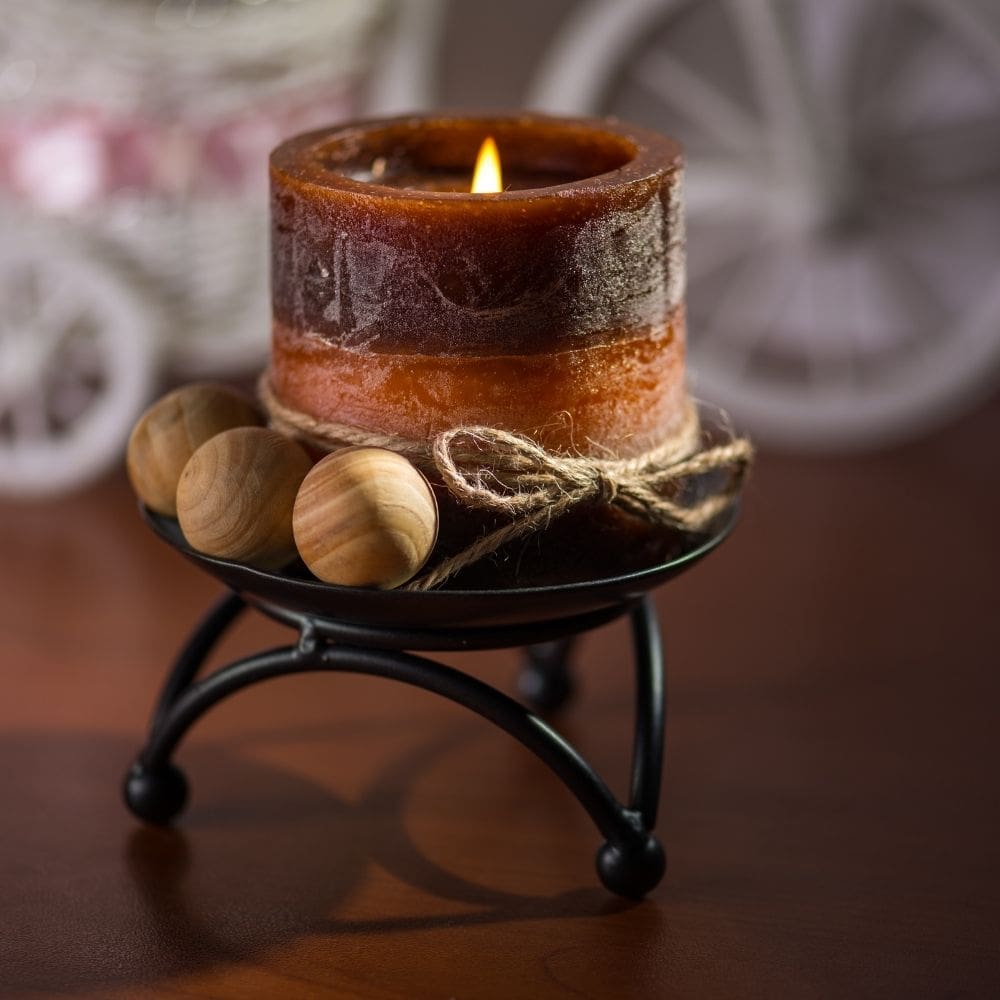 A small brown candle in a candle holder