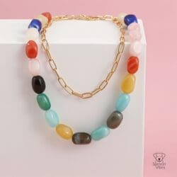 The Multicolour Bead & Gold-Tone Chain Necklace is displayed on a white block against a pink background, with the Spencer Vibes logo in the bottom right corner.