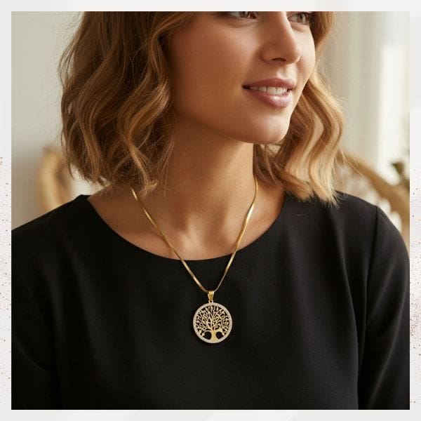Woman wearing a tree of life necklace and a black jumper